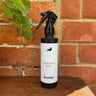 A spray bottle of reproofing spray for use on the waxed canvas bags made by Baxley.