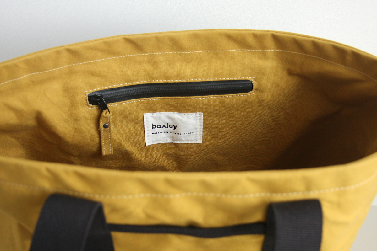 Internal side view of a Hank tote in cumin. A zipped pocket is shown.