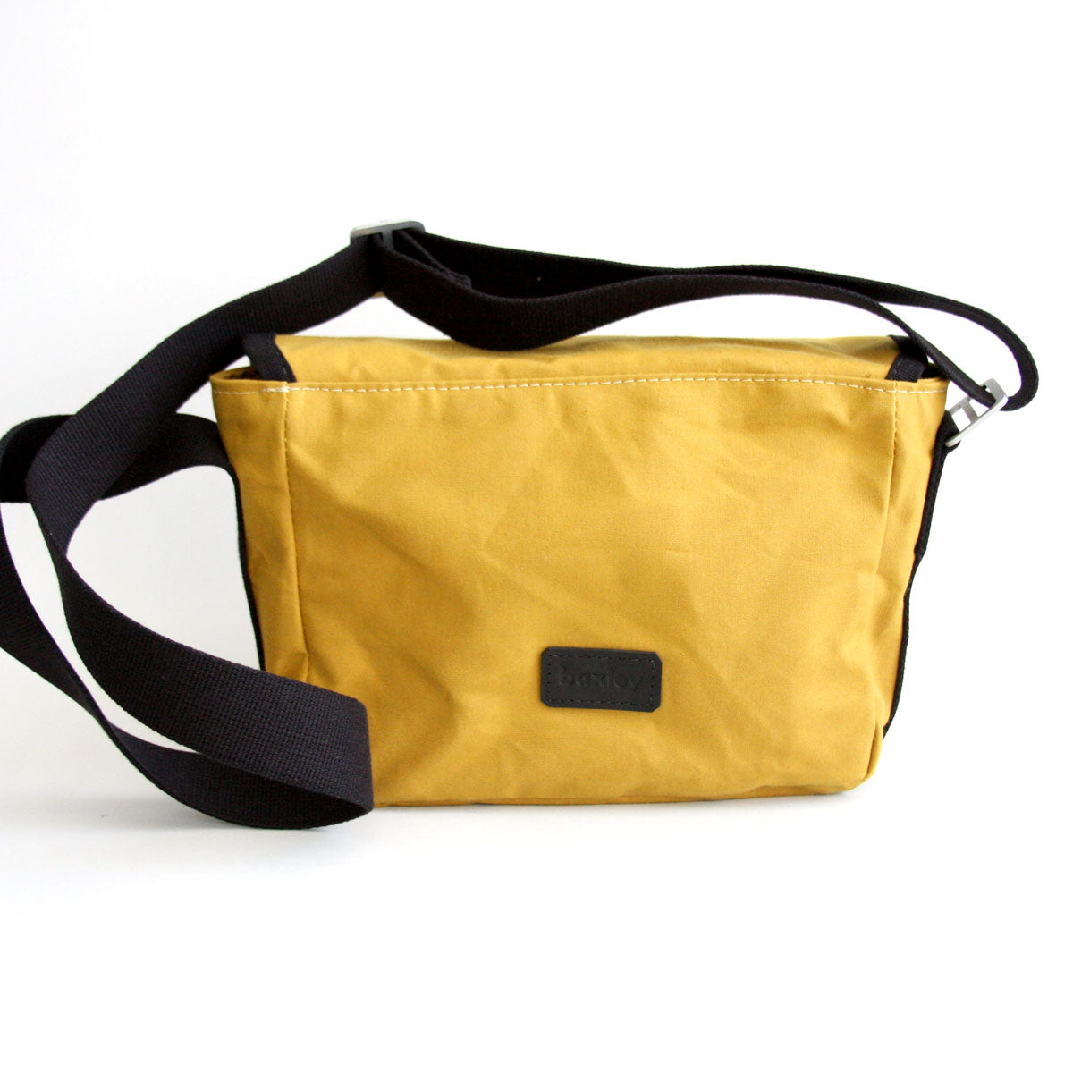 Rear view of Gertie the crossbody satchel from Baxley in cumin and black